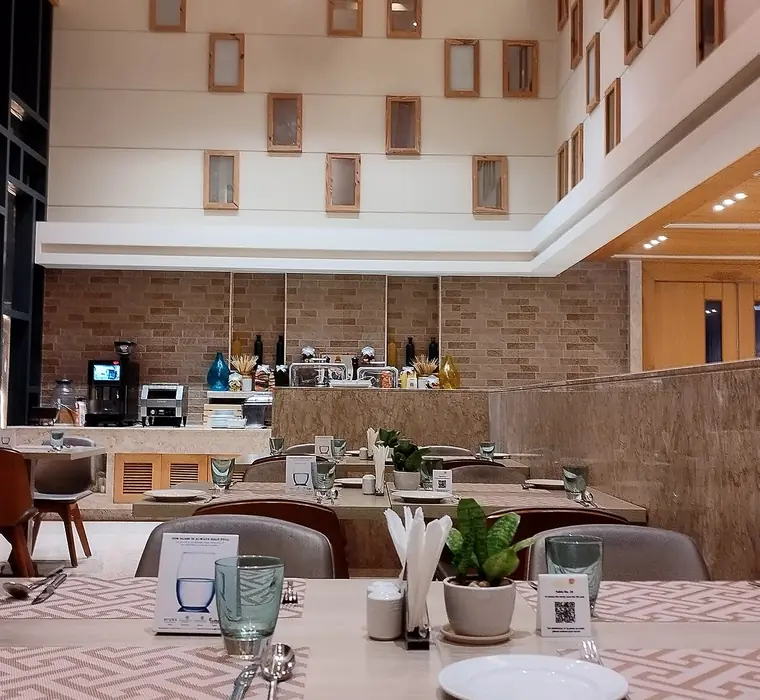 Laid tables and a service counter inside a modern restaurant