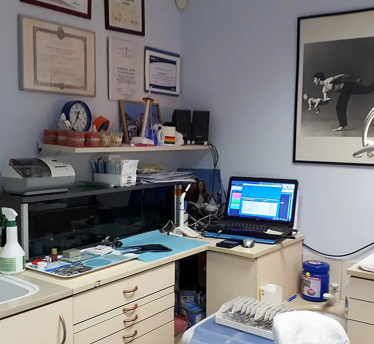 Consulting room of a small clinic with equipment and framed certificates